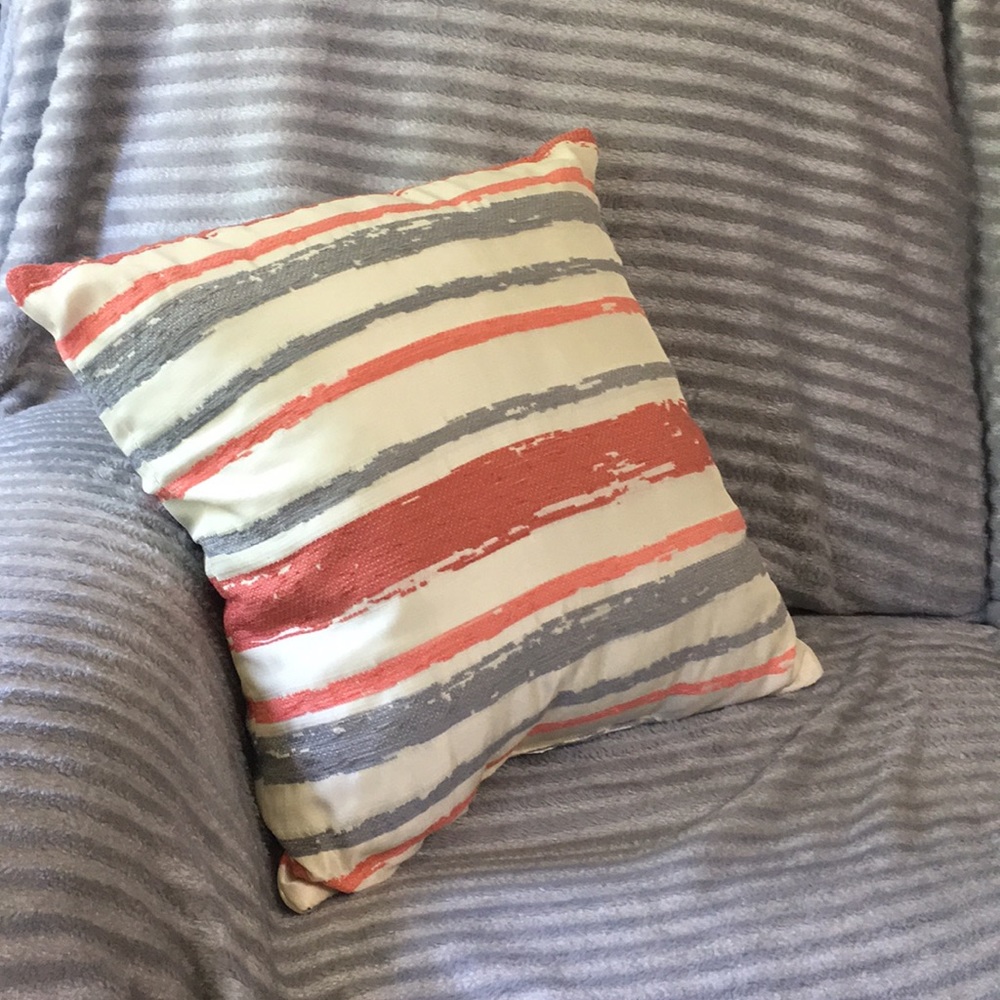 Coral, beige, and grey throw pillow.